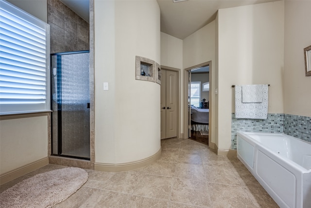 bathroom featuring tile patterned floors and independent shower and bath