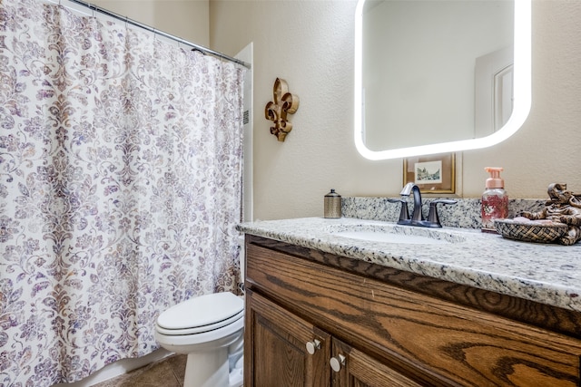 bathroom featuring vanity, toilet, curtained shower, and tile patterned flooring