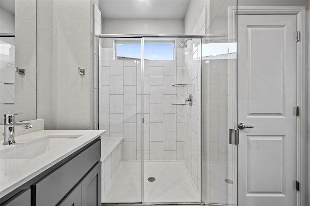 bathroom featuring a stall shower and vanity