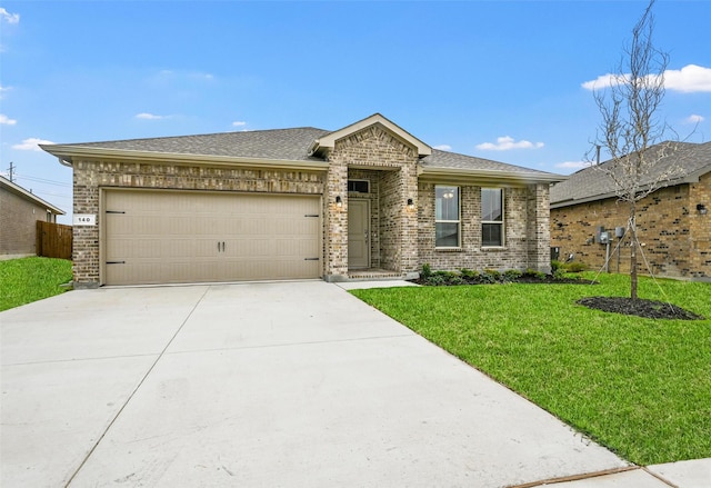 view of front of property with concrete driveway, a shingled roof, an attached garage, brick siding, and a front lawn