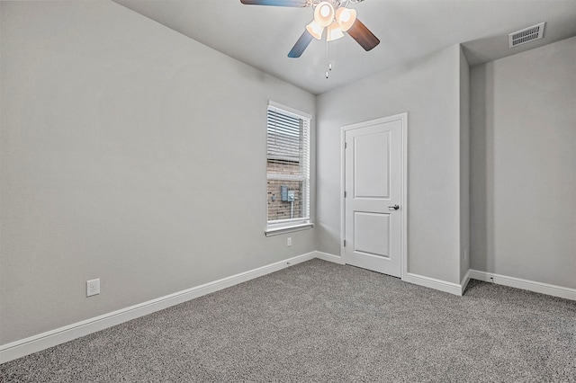 spare room with ceiling fan, a wealth of natural light, and carpet floors