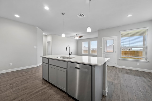 kitchen with stainless steel appliances, wood-type flooring, sink, and a center island with sink