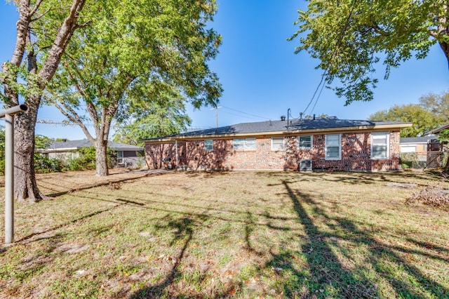 rear view of property featuring a yard