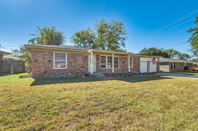 ranch-style home with a front lawn and a garage