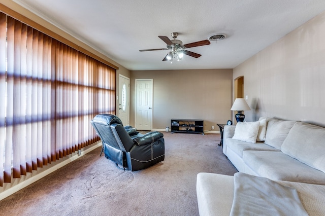 living room featuring carpet and ceiling fan