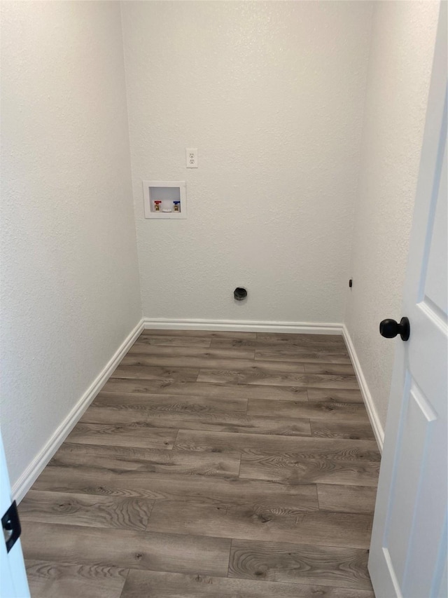 clothes washing area with washer hookup and dark hardwood / wood-style flooring