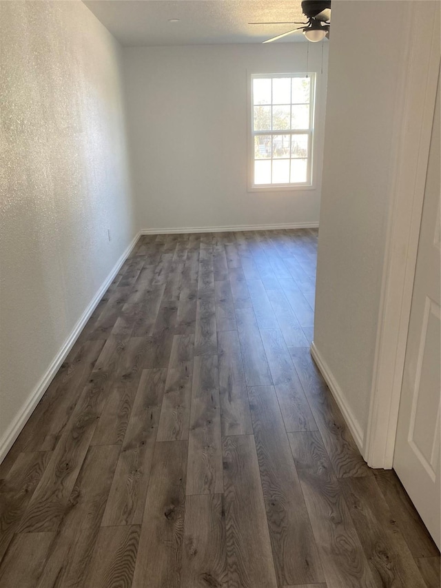 empty room featuring dark hardwood / wood-style floors and ceiling fan