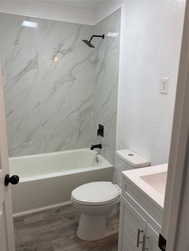 full bathroom with vanity, toilet, tiled shower / bath combo, and hardwood / wood-style floors