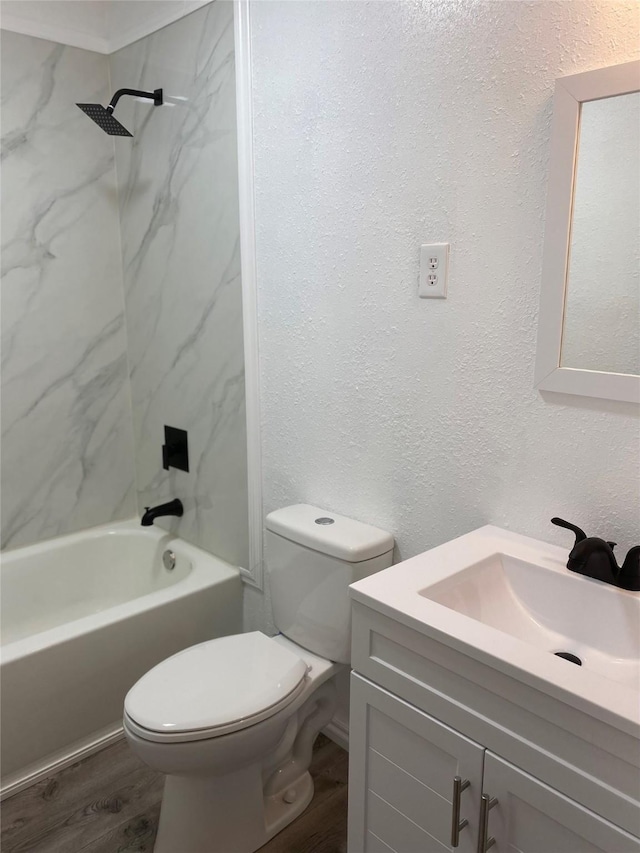 full bathroom with tiled shower / bath, vanity, toilet, and hardwood / wood-style floors