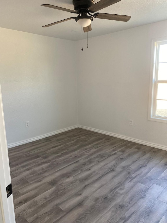 spare room with ceiling fan, a textured ceiling, and dark hardwood / wood-style flooring