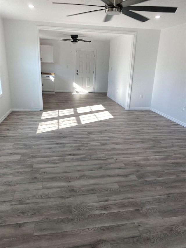 empty room featuring dark hardwood / wood-style floors and ceiling fan