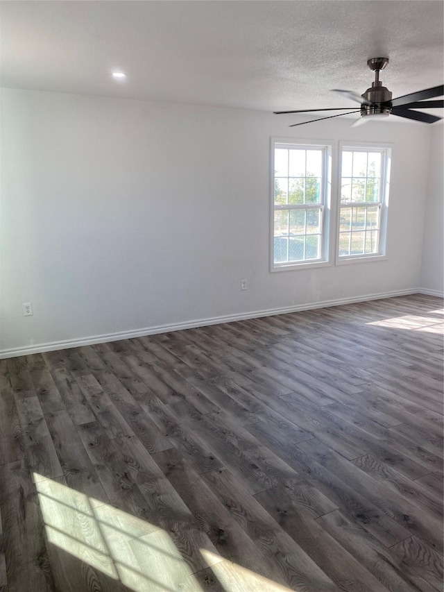 spare room with ceiling fan, dark hardwood / wood-style flooring, and a textured ceiling