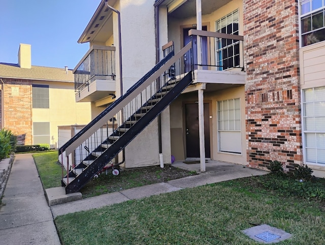 entrance to property with a lawn