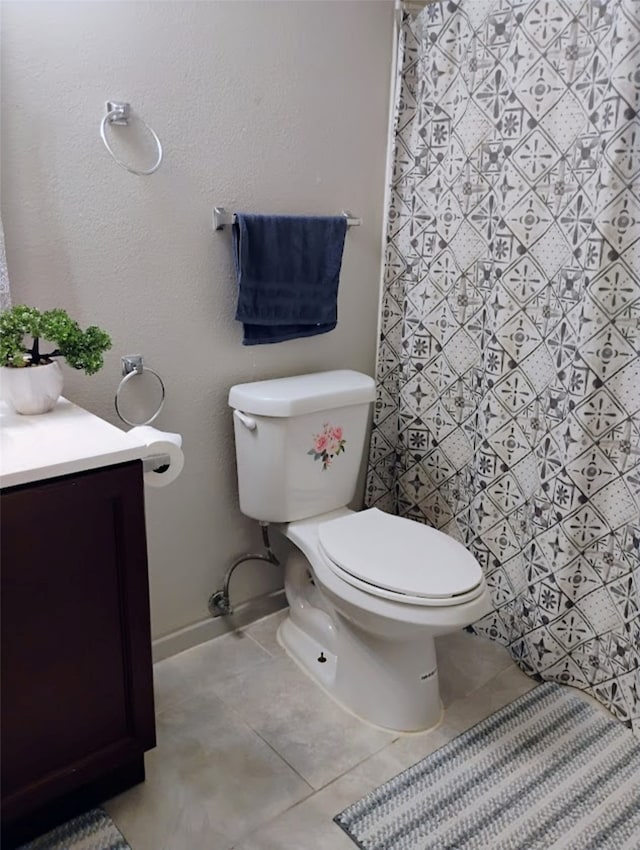 bathroom featuring tile patterned flooring, vanity, and toilet