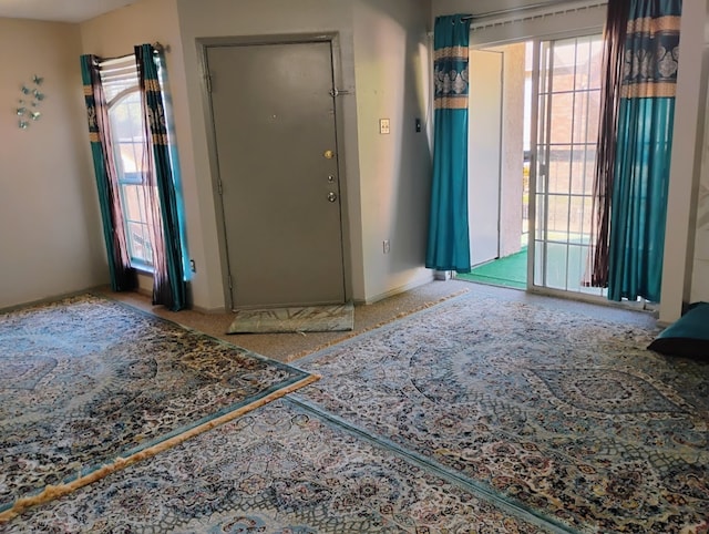 foyer entrance featuring light colored carpet