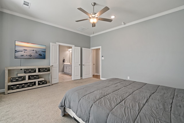 carpeted bedroom featuring crown molding, ensuite bathroom, and ceiling fan