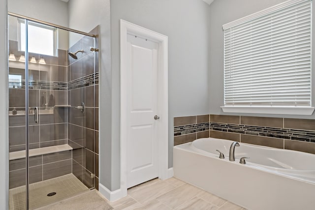 bathroom featuring separate shower and tub