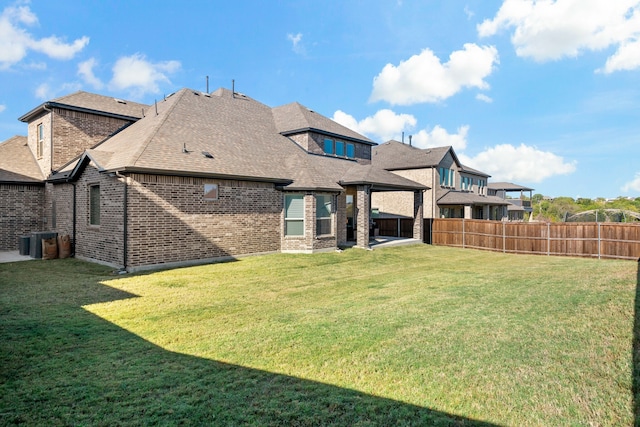 back of house featuring a yard and a patio area