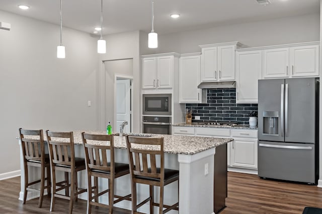 kitchen featuring white cabinetry, stainless steel appliances, dark hardwood / wood-style floors, and an island with sink