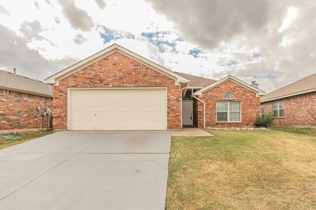 ranch-style home with a garage and a front yard