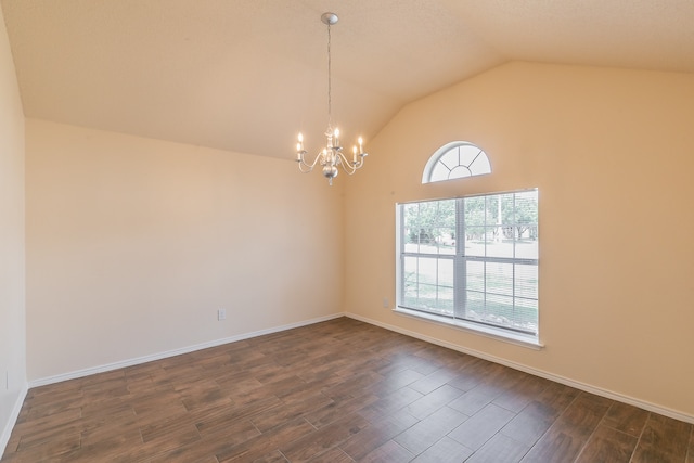 empty room featuring a chandelier, dark wood-type flooring, and lofted ceiling