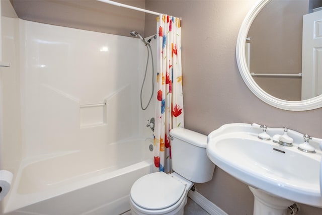 full bathroom featuring sink, shower / bath combination with curtain, and toilet