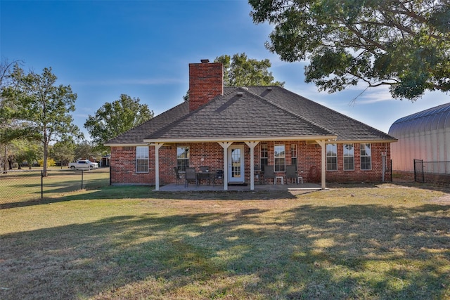 back of property featuring a yard and a patio area