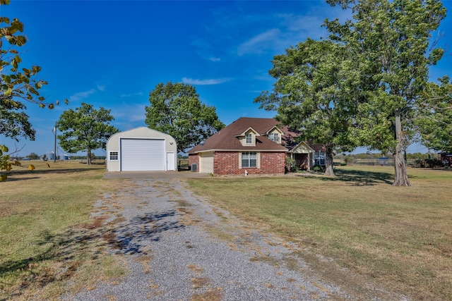 view of front facade with an outbuilding, a garage, and a front yard