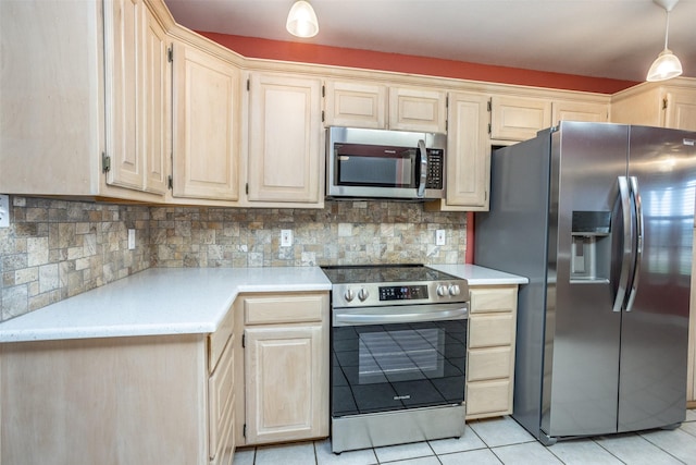 kitchen featuring light tile patterned floors, decorative light fixtures, backsplash, and appliances with stainless steel finishes