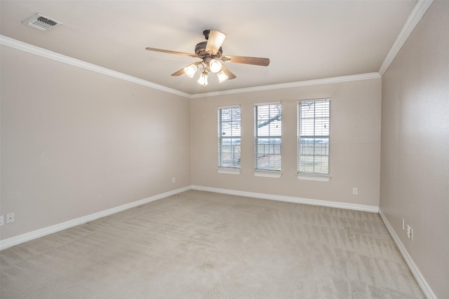 empty room featuring ornamental molding, light colored carpet, and ceiling fan