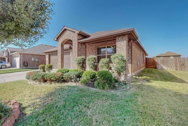 ranch-style house featuring a garage and a front yard