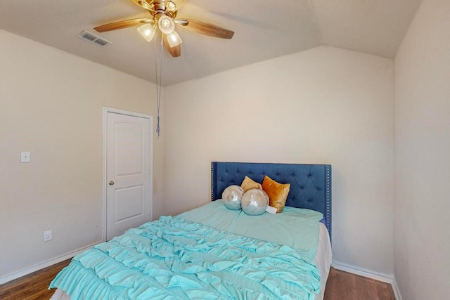 bedroom with ceiling fan, dark hardwood / wood-style flooring, and vaulted ceiling