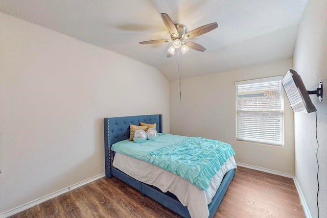 bedroom with ceiling fan, dark hardwood / wood-style flooring, and vaulted ceiling