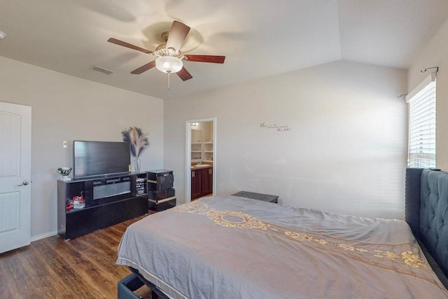 bedroom with ceiling fan, dark hardwood / wood-style flooring, ensuite bath, and vaulted ceiling