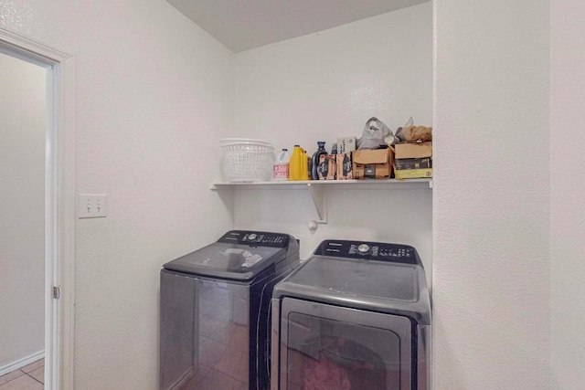 washroom with washing machine and dryer and light tile patterned flooring