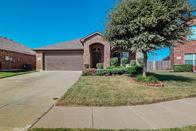 view of front of house with a garage, central air condition unit, and a front yard