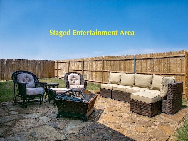 view of patio with an outdoor living space with a fire pit