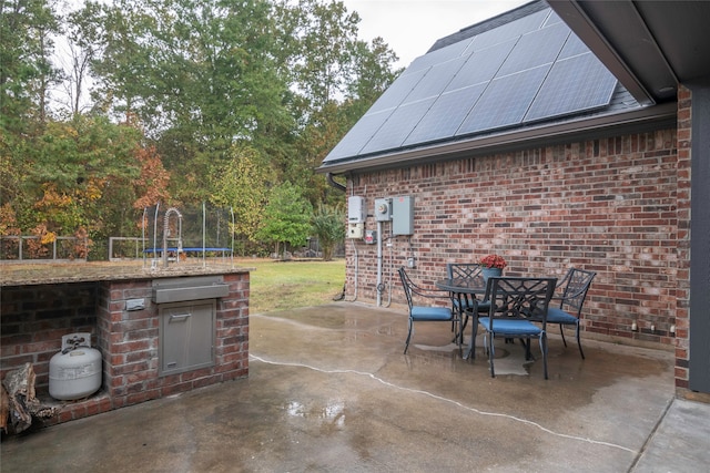 view of patio / terrace with a trampoline and sink