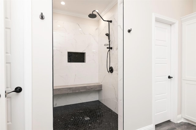 bathroom with tiled shower, hardwood / wood-style flooring, and ornamental molding