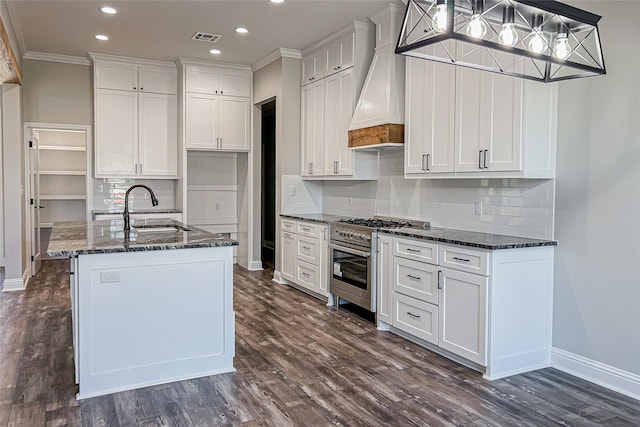 kitchen featuring custom exhaust hood, white cabinets, crown molding, sink, and high end stove