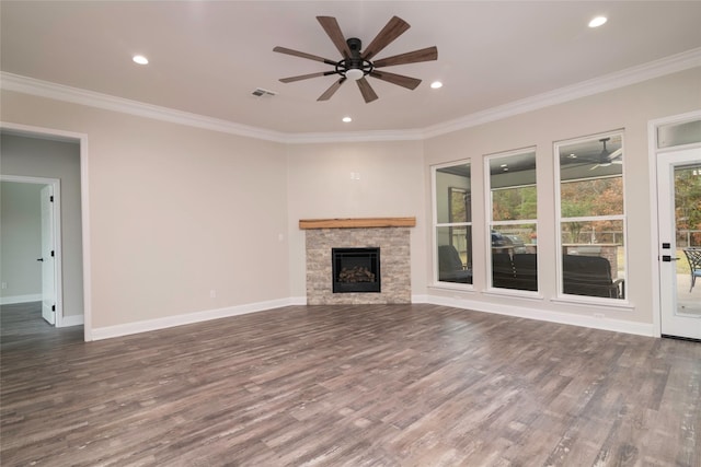 unfurnished living room featuring crown molding, a fireplace, and dark wood-type flooring