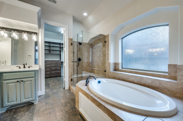 bathroom with vanity, shower with separate bathtub, and hardwood / wood-style flooring