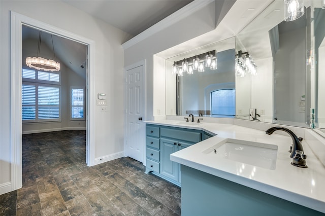 bathroom featuring hardwood / wood-style floors, vanity, vaulted ceiling, and a notable chandelier