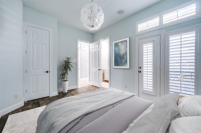 bedroom featuring multiple windows and an inviting chandelier