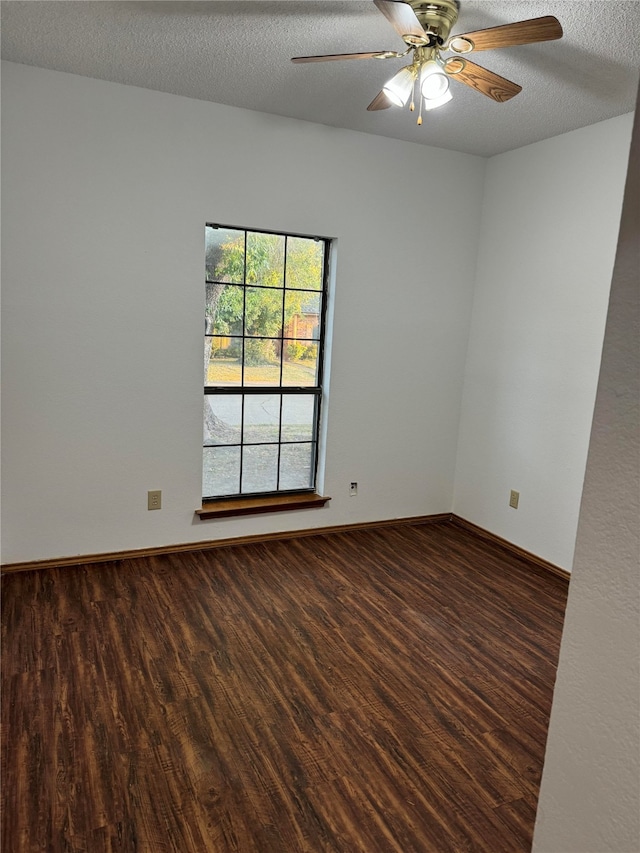 empty room with ceiling fan, a textured ceiling, and dark hardwood / wood-style flooring