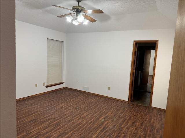 unfurnished room with ceiling fan, a textured ceiling, and dark hardwood / wood-style flooring