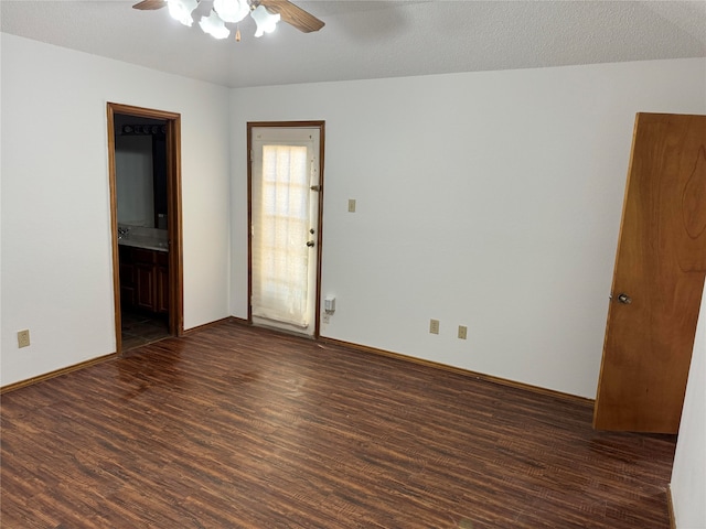 unfurnished room with a textured ceiling, dark hardwood / wood-style floors, and ceiling fan