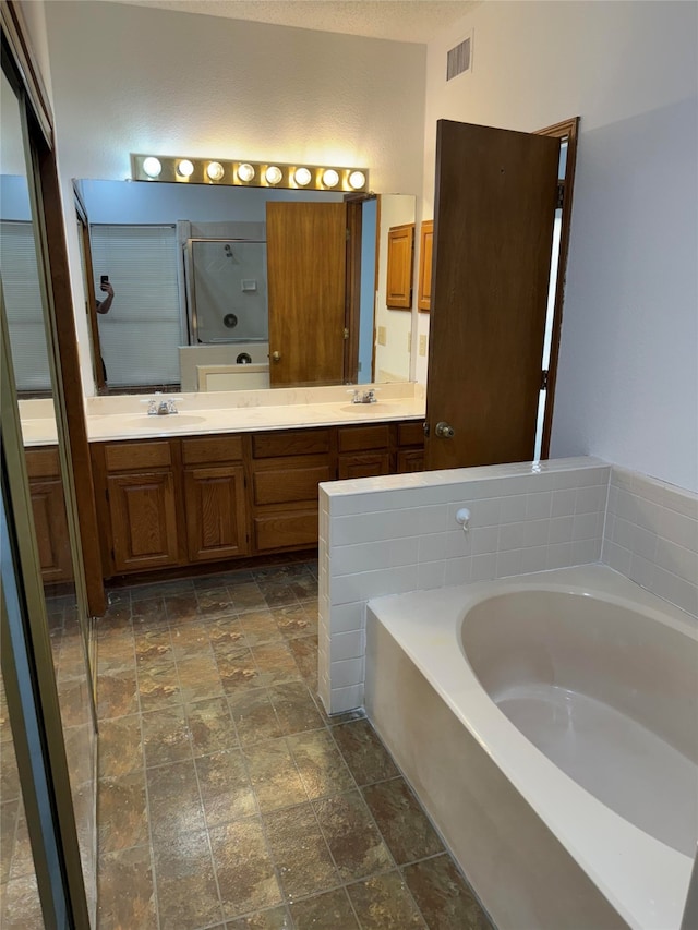 bathroom featuring vanity and plus walk in shower