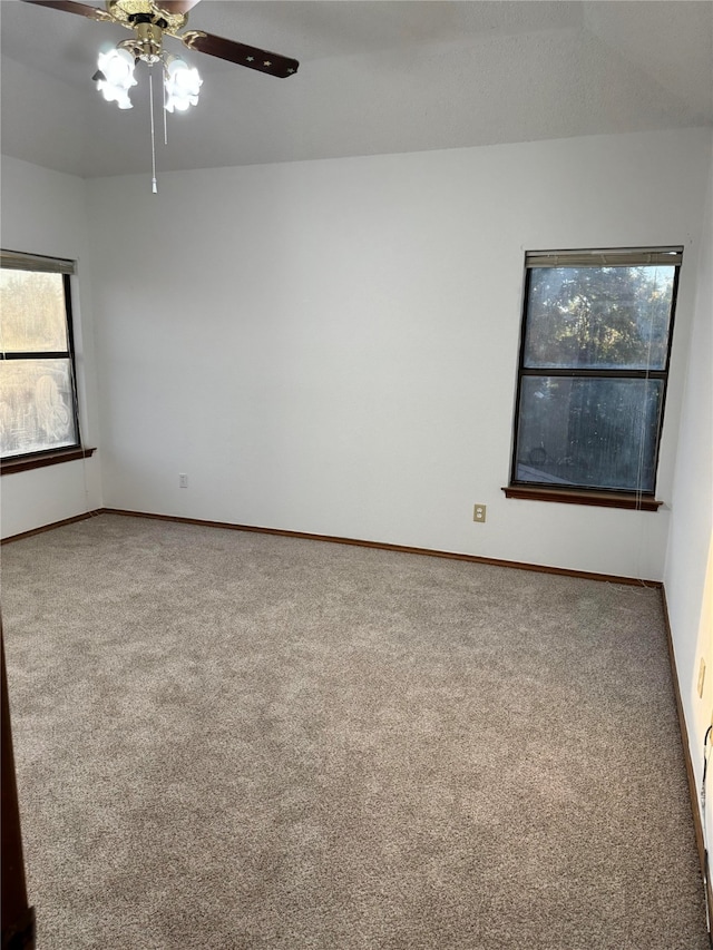 carpeted empty room featuring ceiling fan