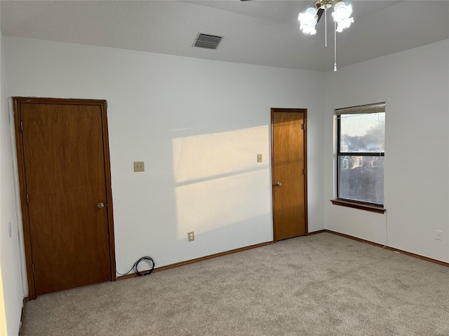 empty room with light carpet and ceiling fan